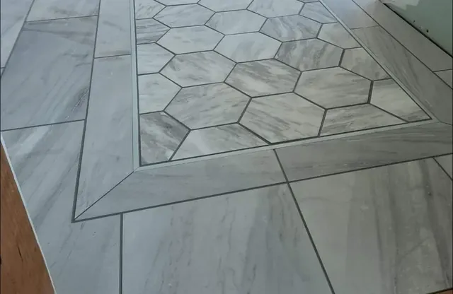 Marble-look porcelain tile with a hexagon inset and mitered border, installed in Southbury, CT